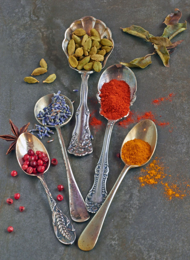 Spices and herbs in small glass jars pouring onto white marble s Poster by  Thomas Baker - Fine Art America