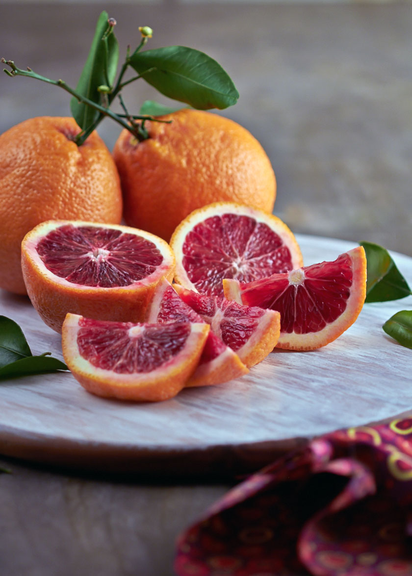 Blood oranges are orange on the outside but hold crimson fruit inside. By The Messy Baker.